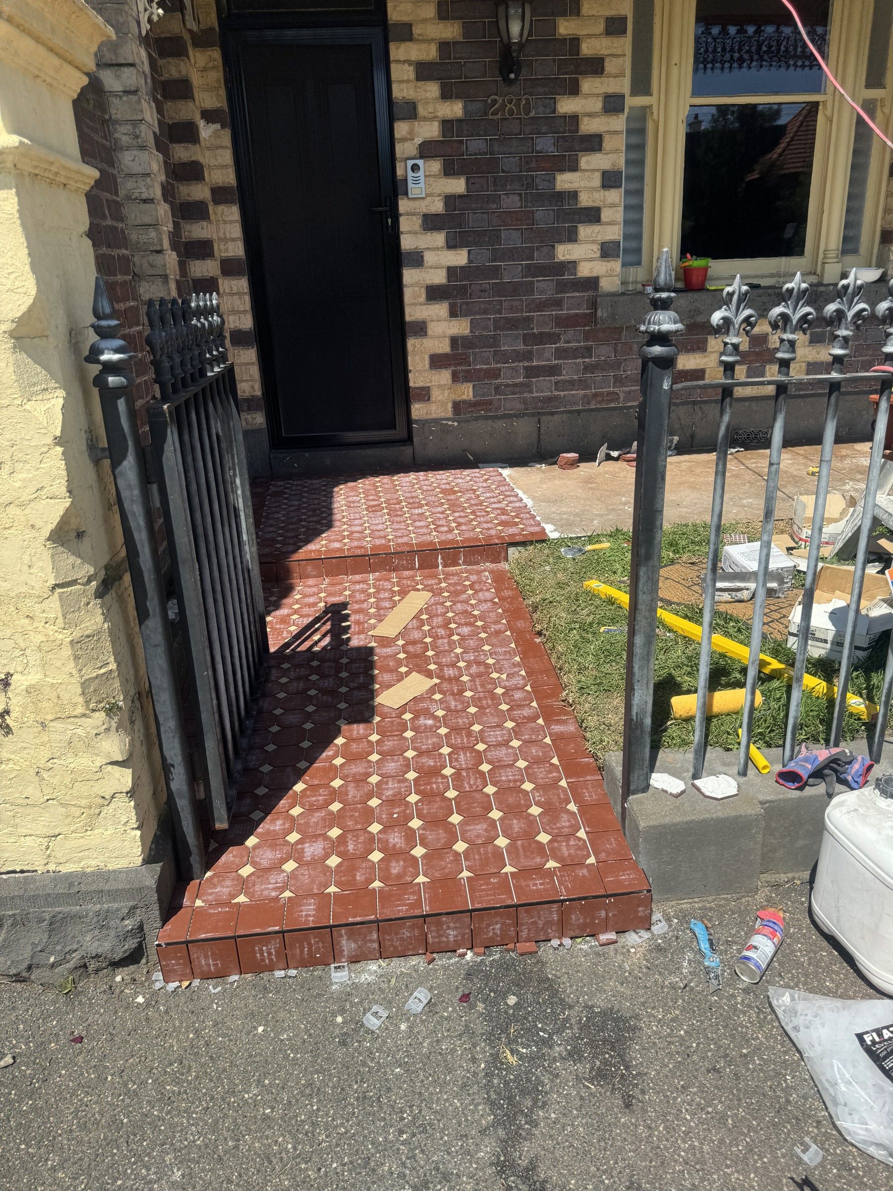 Patterned red and cream external entrance step and path tiling